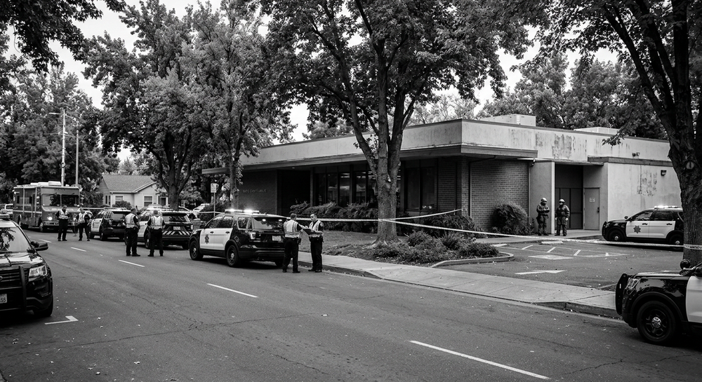 Police vehicles outside the Chico library in Chico, California, after the fatal shooting investigation