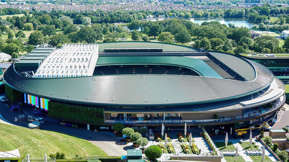 Wimbledon tennis courts in London during The Championships, with players and spectators at the 2026 tournament venue.