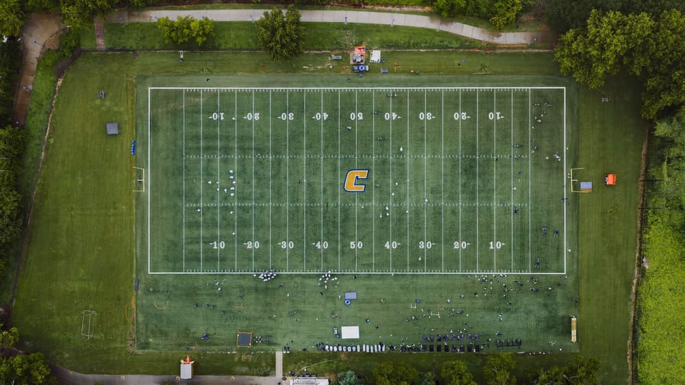 High school football players practice on a field in Chattanooga as teams prepare for the upcoming season.