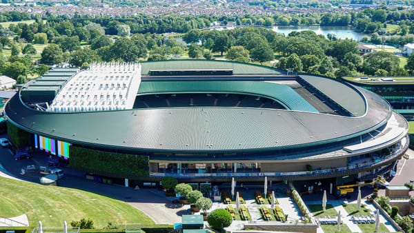 Wimbledon tennis courts in London during The Championships, with players and spectators at the 2026 tournament venue.